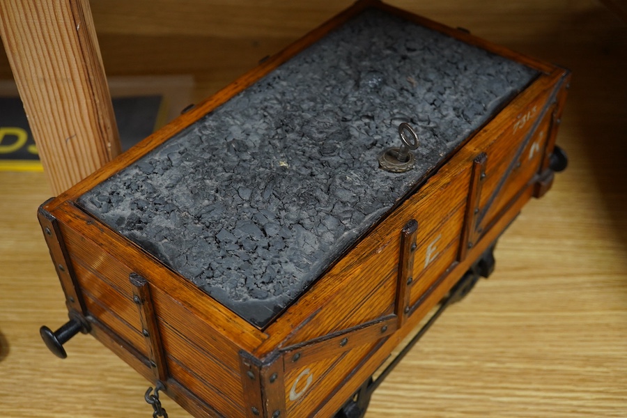 A late 19th or early 20th century novelty cigar box in the form of a railway coal wagon in Great Eastern Railway livery, of oak construction with sectioned interior, integrated match striker, and dummy coal load hiding t